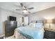 Cozy bedroom with nightstand and a dresser with mounted tv at 14333 W Lexington Ave, Goodyear, AZ 85395