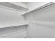 Walk-in closet featuring white walls and metal hanging rods with bright, natural light at 14333 W Lexington Ave, Goodyear, AZ 85395