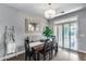 Charming dining room features a chandelier and french doors to the exterior, great for entertaining at 14333 W Lexington Ave, Goodyear, AZ 85395