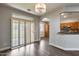 Open-concept dining area with patio access, chandelier, and bar-top pass-through from the kitchen at 14333 W Lexington Ave, Goodyear, AZ 85395