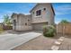 Two story home with desert landscaping, attached two-car garage, with stone pathway on side of house at 14333 W Lexington Ave, Goodyear, AZ 85395