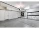 Spacious two-car garage with white walls, a side door, and concrete floors at 14333 W Lexington Ave, Goodyear, AZ 85395
