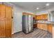 Spacious kitchen featuring stainless steel appliances, wooden cabinets, and modern lighting at 14333 W Lexington Ave, Goodyear, AZ 85395