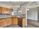 Kitchen includes stainless steel appliances, wooden cabinets, and a view to living area, with a tile backsplash at 14333 W Lexington Ave, Goodyear, AZ 85395