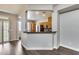 View of the kitchen showcasing wooden cabinets and countertop bar, plus an archway leading to another room at 14333 W Lexington Ave, Goodyear, AZ 85395