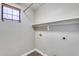 Laundry room with overhead storage and shelf at 14333 W Lexington Ave, Goodyear, AZ 85395