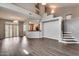 Spacious living room featuring high ceilings, hardwood floors and stairs with bright white risers at 14333 W Lexington Ave, Goodyear, AZ 85395