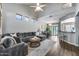 Cozy living room flows to dining area, featuring hardwood floors and neutral paint scheme at 14333 W Lexington Ave, Goodyear, AZ 85395