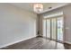 Well-lit living room has wood-look floors and white shutters creating a welcoming and comfortable living space at 14333 W Lexington Ave, Goodyear, AZ 85395