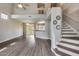 Spacious living room featuring wood floors, an open concept, high ceilings, and a staircase at 14333 W Lexington Ave, Goodyear, AZ 85395