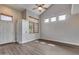 Bright living room boasts wood-look floors, high ceilings, and a neutral paint scheme for a modern, airy feel at 14333 W Lexington Ave, Goodyear, AZ 85395