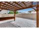 Backyard with a covered pergola and brick patio; perfect for entertaining and relaxation at 14333 W Lexington Ave, Goodyear, AZ 85395