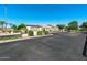 Community street view with lush landscaping and the community 'Village' sign at 14333 W Lexington Ave, Goodyear, AZ 85395