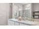 Elegant bathroom with dual sinks, marble countertops, and a glass-enclosed shower at 15362 W Cottontail Ln, Surprise, AZ 85387