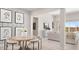 Stylish dining room with modern art, a round table, and seating for six at 15362 W Cottontail Ln, Surprise, AZ 85387
