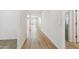 Long hallway featuring wood-style tile flooring and access to multiple rooms at 15362 W Cottontail Ln, Surprise, AZ 85387