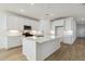 Modern kitchen with a central island, white cabinetry, and stainless steel appliances at 15362 W Cottontail Ln, Surprise, AZ 85387