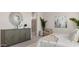 Relaxing main bedroom showcasing a decorative cabinet and a modern ensuite bathroom at 15362 W Cottontail Ln, Surprise, AZ 85387