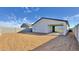 Spacious backyard featuring a stucco home with sliding glass doors and a block wall at 15748 W Beryl Ave, Waddell, AZ 85355