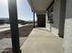 View from the covered front porch showcasing the column, window and desert landscaping at 15748 W Beryl Ave, Waddell, AZ 85355