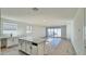 Open-concept kitchen with center island that flows into the bright living area at 15748 W Beryl Ave, Waddell, AZ 85355