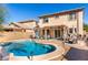 Inviting backyard with a sparkling blue pool, patio seating, and a well-maintained fence at 1623 W Quick Draw Way, San Tan Valley, AZ 85144