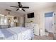 Cozy bedroom with soft carpet, closet, neutral walls, ceiling fan, and bright, natural lighting at 1623 W Quick Draw Way, San Tan Valley, AZ 85144