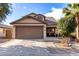 Charming single-story home with a two-car garage, desert landscaping, and a cozy front porch at 1623 W Quick Draw Way, San Tan Valley, AZ 85144