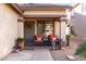 Inviting front porch with comfortable seating and decorative elements, potted plants, and a gated entrance at 1623 W Quick Draw Way, San Tan Valley, AZ 85144