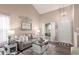 Bright living room with high ceilings, wood floors, neutral walls, stylish furniture, and natural light at 1623 W Quick Draw Way, San Tan Valley, AZ 85144