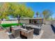 Backyard features artificial grass, patio, lounging and sitting areas with gravel and stepping stones at 1716 N 32Nd Pl, Phoenix, AZ 85008