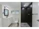 Renovated bathroom featuring a black herringbone shower, white vanity, and modern fixtures at 1716 N 32Nd Pl, Phoenix, AZ 85008