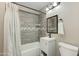 Cozy bathroom featuring updated tile in the shower, a vanity, and tiled walls at 1716 N 32Nd Pl, Phoenix, AZ 85008