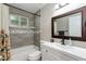 Bathroom features a shower-tub combo, tiled walls, a vanity, and decorative accents at 1716 N 32Nd Pl, Phoenix, AZ 85008