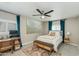 Bedroom with a ceiling fan, large painting, study desk and chair, and bench at the foot of the bed at 1716 N 32Nd Pl, Phoenix, AZ 85008