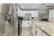 Bright kitchen features an island with bar seating, stainless appliances, and white cabinetry at 1716 N 32Nd Pl, Phoenix, AZ 85008