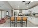 Open concept kitchen featuring a spacious island with counter seating and stainless steel appliances at 1716 N 32Nd Pl, Phoenix, AZ 85008