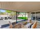 Covered outdoor patio with gravel and stepping stones, furniture seating area, and artificial grass at 1716 N 32Nd Pl, Phoenix, AZ 85008
