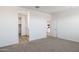Spacious carpeted bedroom with open doors to closet and bathroom at 17813 W Mission Ln, Waddell, AZ 85355