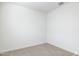 An empty bedroom featuring neutral colored walls and carpet at 17813 W Mission Ln, Waddell, AZ 85355