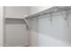 Walk-in closet with neutral carpeting, and simple metal hanging system at 17813 W Mission Ln, Waddell, AZ 85355