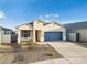 Attractive single-Gathering home with desert landscaping, a blue garage door, and a neatly kept front yard at 17813 W Mission Ln, Waddell, AZ 85355