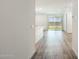 Bright hallway featuring elegant wood-look flooring, leading to an open living space with plenty of natural light at 17813 W Mission Ln, Waddell, AZ 85355