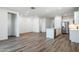 View of the open-concept kitchen with stainless steel appliances and gray wood floor at 17813 W Mission Ln, Waddell, AZ 85355