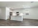 Open-concept kitchen with stainless steel appliances and a large center island at 17813 W Mission Ln, Waddell, AZ 85355