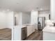 Spacious kitchen with a large island, stainless steel appliances, and modern white cabinets at 17813 W Mission Ln, Waddell, AZ 85355