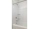 All white stand up shower/tub combo featuring a shower head and two shelves at 17813 W Mission Ln, Waddell, AZ 85355