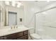 Clean bathroom features a single sink vanity, a glass shower, and neutral finishes for a modern look at 1821 W Vermont Ave, Phoenix, AZ 85015