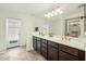 Spacious bathroom with double sinks, dark wood cabinetry, and a glass-enclosed shower at 1821 W Vermont Ave, Phoenix, AZ 85015