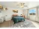 Bright bedroom featuring a ceiling fan, a large window, and decorative wall hangings at 1821 W Vermont Ave, Phoenix, AZ 85015